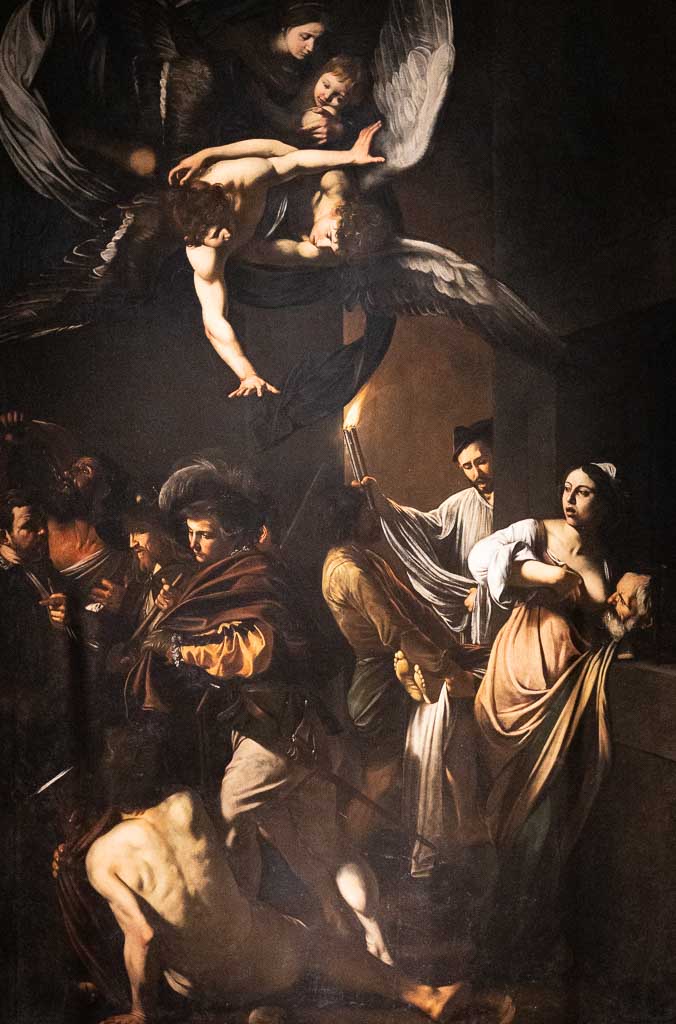 Ein Gemälde von Caravaggio in Neapel mit fliegenden Engeln und einfachen Leuten.